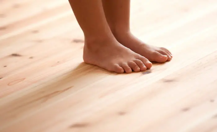 木の床に素足で立っている様子